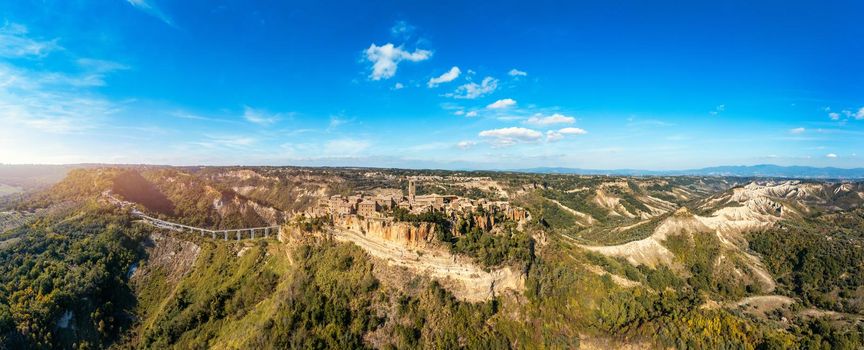 The famous Civita di Bagnoregio on a sunny day. Province of Viterbo, Lazio, Italy. Medieval town on the mountain, Civita di Bagnoregio, popular touristic stop at Tuscany, Italy.