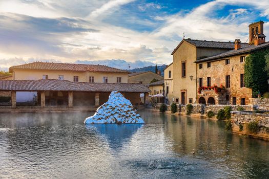 Thermal bath town of Bagno Vignoni, Italy during sunrise. Old thermal baths in the medieval village Bagno Vignoni, Tuscany, Italy. Medieval thermal baths in village Bagno Vignoni, Tuscany, Italy 