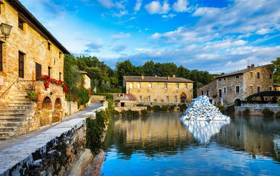 Thermal bath town of Bagno Vignoni, Italy during sunrise. Old thermal baths in the medieval village Bagno Vignoni, Tuscany, Italy. Medieval thermal baths in village Bagno Vignoni, Tuscany, Italy 
