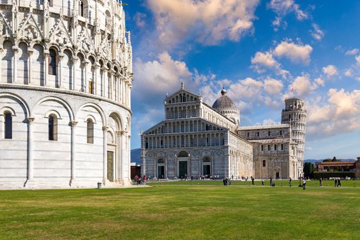 Pisa Cathedral and the Leaning Tower in a sunny day in Pisa, Italy. Pisa Cathedral with Leaning Tower of Pisa on Piazza dei Miracoli in Pisa, Tuscany, Italy.