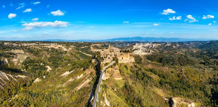 The famous Civita di Bagnoregio on a sunny day. Province of Viterbo, Lazio, Italy. Medieval town on the mountain, Civita di Bagnoregio, popular touristic stop at Tuscany, Italy.