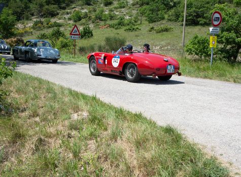 URBINO - ITALY - JUN 16 - 2022 : ALFA ROMEO 1900 SPORT SPIDER 1954 on an old racing car in rally Mille Miglia 2022 the famous italian historical race (1927-1957