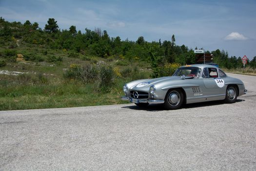 URBINO - ITALY - JUN 16 - 2022 : MERCEDES-BENZ 300 SL (W198) 1954 on an old racing car in rally Mille Miglia 2022 the famous italian historical race (1927-1957