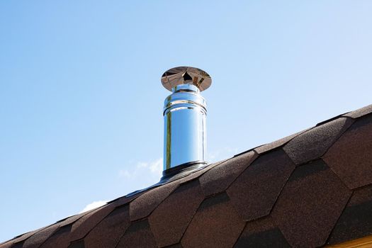 Metal stove pipe on the roof close up