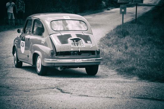 URBINO - ITALY - JUN 16 - 2022 : FIAT 600 1956 on an old racing car in rally Mille Miglia 2022 the famous italian historical race (1927-1957