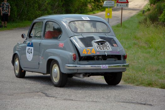 URBINO - ITALY - JUN 16 - 2022 : FIAT 600 1956 on an old racing car in rally Mille Miglia 2022 the famous italian historical race (1927-1957