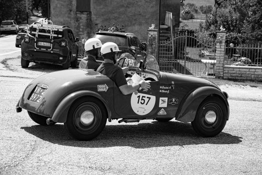 URBINO - ITALY - JUN 16 - 2022 : FIAT 500 SPORT 1949 on an old racing car in rally Mille Miglia 2022 the famous italian historical race (1927-1957