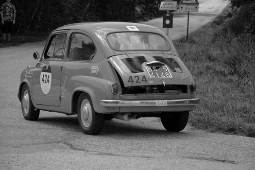 URBINO - ITALY - JUN 16 - 2022 : FIAT 600 1956 on an old racing car in rally Mille Miglia 2022 the famous italian historical race (1927-1957URBINO - ITALY - JUN 16 - 2022 : FIAT 600 1956 on an old racing car in rally Mille Miglia 2022 the famous italian historical race (1927-1957