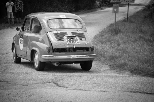 URBINO - ITALY - JUN 16 - 2022 : FIAT 600 1956 on an old racing car in rally Mille Miglia 2022 the famous italian historical race (1927-1957