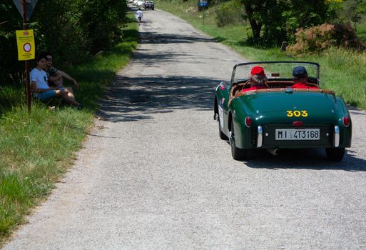 URBINO - ITALY - JUN 16 - 2022 : TRIUMPH TR2 SPORTS 1954 on an old racing car in rally Mille Miglia 2022 the famous italian historical race (1927-1957