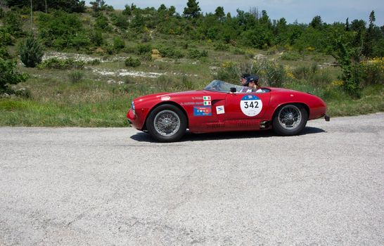 URBINO - ITALY - JUN 16 - 2022 : ALFA ROMEO 1900 SPORT SPIDER 1954 on an old racing car in rally Mille Miglia 2022 the famous italian historical race (1927-1957