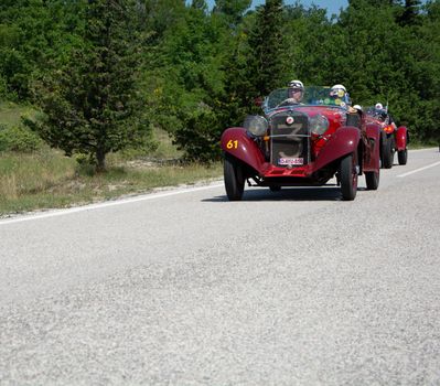 URBINO - ITALY - JUN 16 - 2022 : fiat on an old racing car in rally Mille Miglia 2022 the famous italian historical race (1927-1957