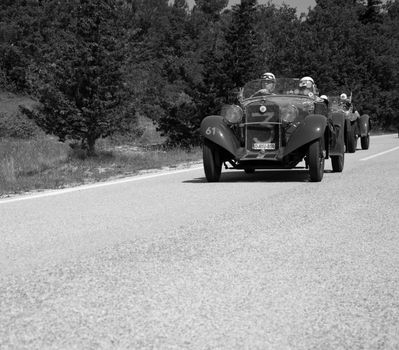 URBINO - ITALY - JUN 16 - 2022 : fiat on an old racing car in rally Mille Miglia 2022 the famous italian historical race (1927-1957