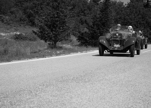 URBINO - ITALY - JUN 16 - 2022 : fiat on an old racing car in rally Mille Miglia 2022 the famous italian historical race (1927-1957