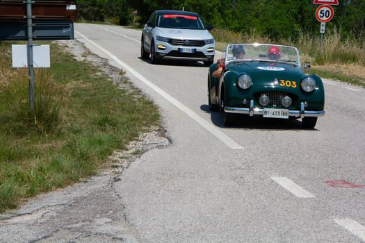 URBINO - ITALY - JUN 16 - 2022 : TRIUMPH TR2 SPORTS 1954 on an old racing car in rally Mille Miglia 2022 the famous italian historical race (1927-1957