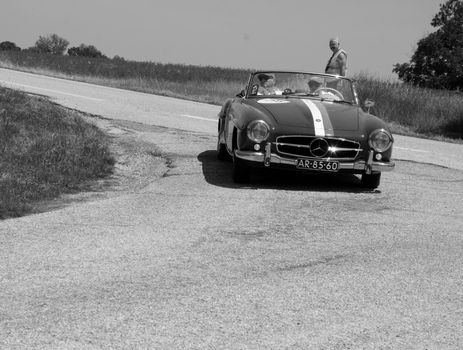 URBINO - ITALY - JUN 16 - 2022 : MERCEDES-BENZ 190 SL 1957 on an old racing car in rally Mille Miglia 2022 the famous italian historical race (1927-1957