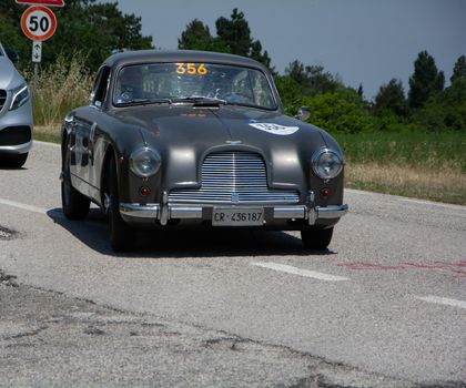 URBINO - ITALY - JUN 16 - 2022 : ASTON MARTIN DB 2/4 1955 on an old racing car in rally Mille Miglia 2022 the famous italian historical race (1927-1957