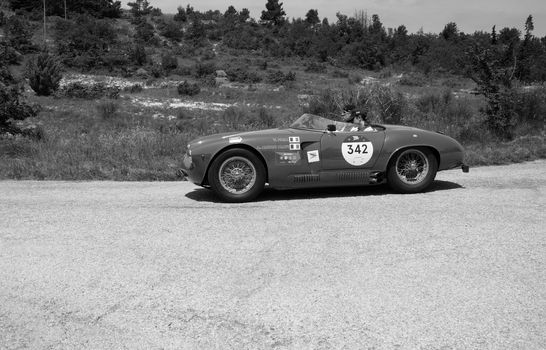 URBINO - ITALY - JUN 16 - 2022 : ALFA ROMEO 1900 SPORT SPIDER 1954 on an old racing car in rally Mille Miglia 2022 the famous italian historical race (1927-1957