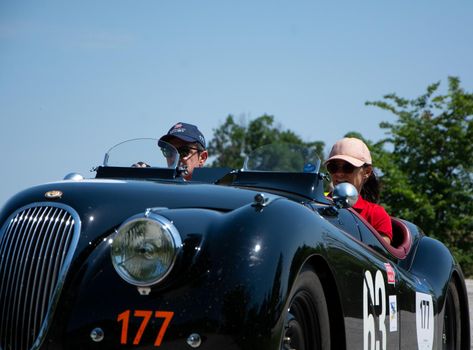 URBINO - ITALY - JUN 16 - 2022 : JAGUAR XK120 OTS ROADSTER 1950 on an old racing car in rally Mille Miglia 2022 the famous italian historical race (1927-1957