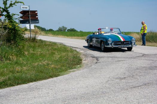 URBINO - ITALY - JUN 16 - 2022 : MERCEDES-BENZ 190 SL 1957 on an old racing car in rally Mille Miglia 2022 the famous italian historical race (1927-1957