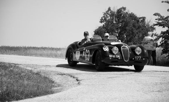 URBINO - ITALY - JUN 16 - 2022 : JAGUAR XK120 OTS ROADSTER 1950 on an old racing car in rally Mille Miglia 2022 the famous italian historical race (1927-1957