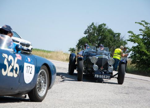 URBINO - ITALY - JUN 16 - 2022 : ASTON MARTIN LE MANS 1933on an old racing car in rally Mille Miglia 2022 the famous italian historical race (1927-1957