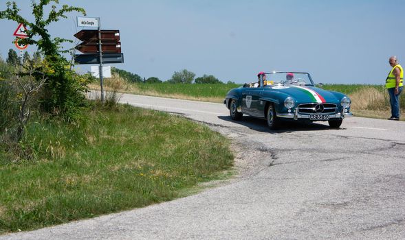 URBINO - ITALY - JUN 16 - 2022 : MERCEDES-BENZ 190 SL 1957 on an old racing car in rally Mille Miglia 2022 the famous italian historical race (1927-1957