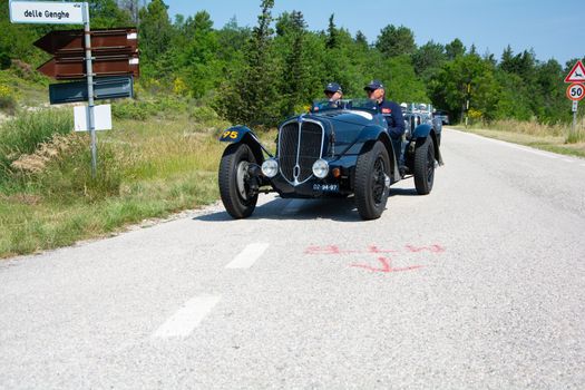 URBINO - ITALY - JUN 16 - 2022 : DELAHAYE 135 CS 1936 on an old racing car in rally Mille Miglia 2022 the famous italian historical race (1927-1957