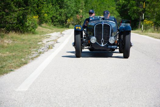 URBINO - ITALY - JUN 16 - 2022 : DELAHAYE 135 CS 1936 on an old racing car in rally Mille Miglia 2022 the famous italian historical race (1927-1957