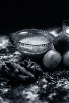 Lemon face mask on the wooden surface consisting lemon juice, gram flour or chickpea flour, turmeric or Haldi and milk in a glass bowl.For the treatment of tans.