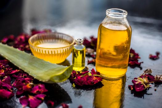 The trio pack of herbs and ingredients to fight dandruff on the wooden surface well mixed in a glass bowl which are castor oil, tea tree oil, and some aloe vera gel. Also used to treat itchiness.;