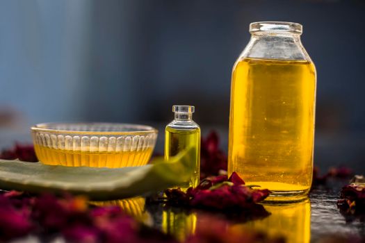 The trio pack of herbs and ingredients to fight dandruff on the wooden surface well mixed in a glass bowl which are castor oil, tea tree oil, and some aloe vera gel. Also used to treat itchiness.;