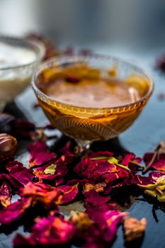 Nutmeg face mask to treat to even out discolorations and pigmentation on your face on the wooden surface consisting of Nutmeg powder, lemon juice, and curd.