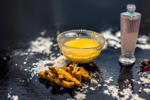 Gram flour or chickpea flour well mixed with turmeric using rose water in a glass bowl and making gram flour face mask for maintaining the pH of the skin.