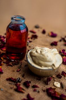 Ubtan/face mask/face pack of Multani mitti or fuller's earth on Gunny Bag surface in a glass bowl consisting of Multani mitti and rose water for the remedy or treatment of oily skin.