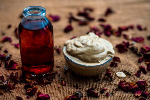 Ubtan/face mask/face pack of Multani mitti or fuller's earth on Gunny Bag surface in a glass bowl consisting of Multani mitti and rose water for the remedy or treatment of oily skin.