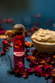 Ubtan/face mask/face pack of Multani mitti or fuller's earth on wooden surface in a glass bowl consisting of Multani mitti and rose water for the remedy or treatment of oily skin.On wooden surface.