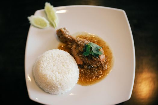 Thai Asian food. Baked Chicken with sauce and rice in restaurant.