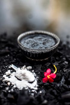 Activated charcoal well mixed with baking soda to detoxify strands and scalp, restore shine, repair damaged and split ends, and promote healthy, fast hair growth.On wooden surface.