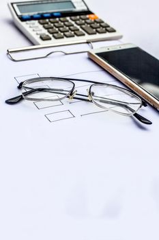 Close up of workplace of businessman or finance consultant isolated on white using credit card, cell phone, pen and calculator like things and some coins also.