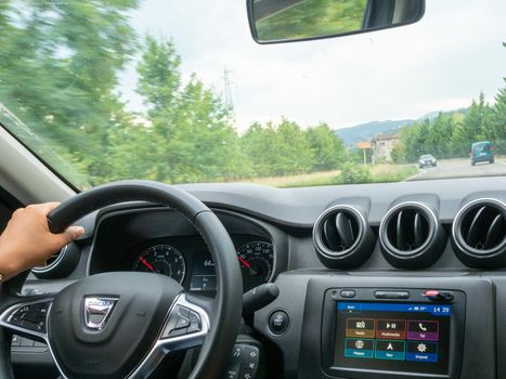 Beautiful business lady driving her car a cloudy day in summertime