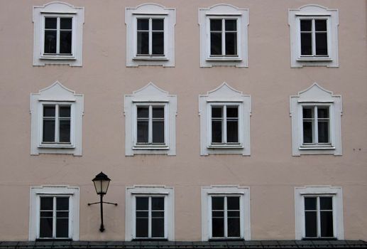 Classic style facade in Salzburg with some windows and a street lamp
