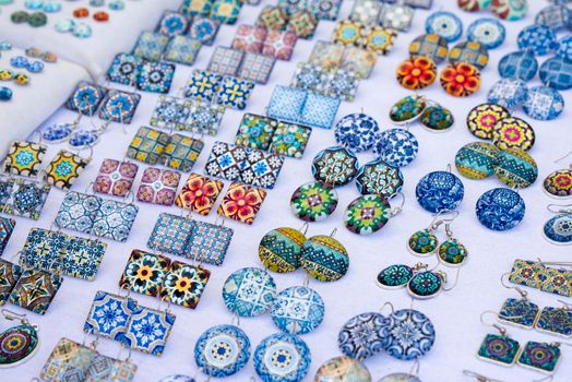 Glass square and round earrings with azulejo elements on the market in Porto