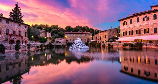Thermal bath town of Bagno Vignoni, Italy during sunrise. Old thermal baths in the medieval village Bagno Vignoni, Tuscany, Italy. Medieval thermal baths in village Bagno Vignoni, Tuscany, Italy 