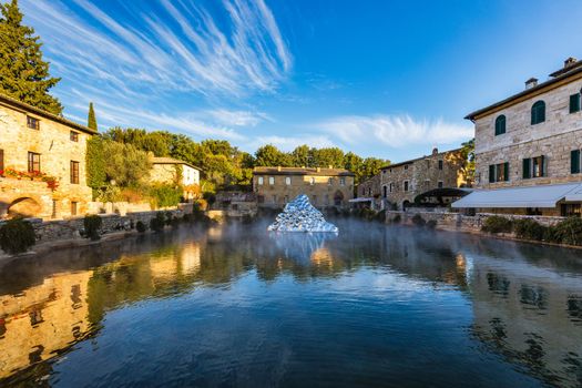 Thermal bath town of Bagno Vignoni, Italy during sunrise. Old thermal baths in the medieval village Bagno Vignoni, Tuscany, Italy. Medieval thermal baths in village Bagno Vignoni, Tuscany, Italy 