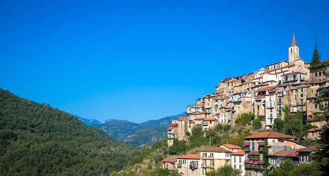 APRICALE, ITALY - CIRCA AUGUST 2020: traditional old village made of stones located in Italian Liguria region  with blue sky and copyspace