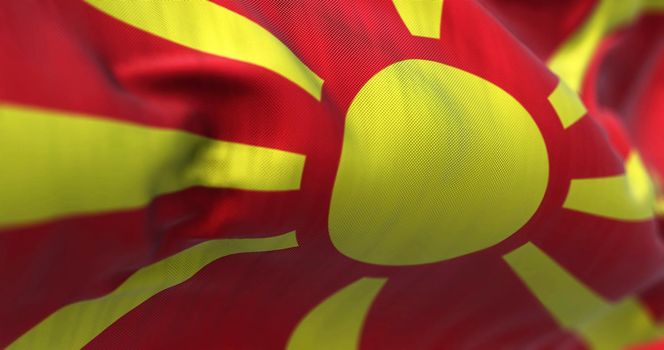 Close-up view of the North Macedonia national flag waving in the wind. Republic of North Macedonia is a country in Southeast Europe. Fabric textured background. Selective focus