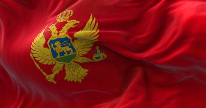Close-up view of the Montenegro national flag waving in the wind. Montenegro is a country in Southeastern Europe. Fabric textured background. Selective focus