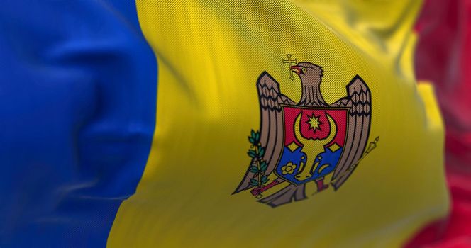 Close-up view of the Moldova national flag waving in the wind. Republic of Moldova is a landlocked country in Eastern Europe. Fabric textured background. Selective focus