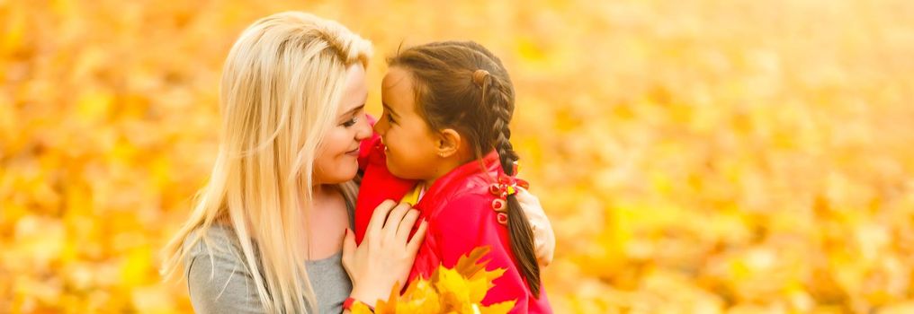 happy family mother with her daughter playing and laughing on autumn walk